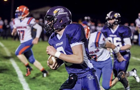 Grand Meadow quarterback Michael Stejskal on a carry in the first quarter against Randolph Friday night in Grand Meadow. Eric Johnson/photodesk@austindailyherald.com