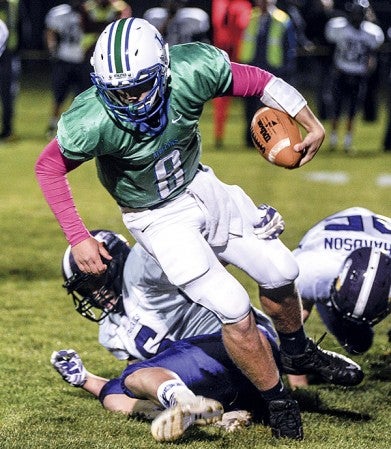 Lyle-Pacelli's Jordan Hart tries to spin out of a tackle by Grand Meadow's Blake Benson during the first quarter of Friday night's game in Lyle. Eric Johnson/photodesk@austindailyherald.com