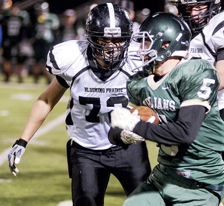 Blooming Prairi'es Collin Wobschall closes in on Rushford-Peterson's Alex Vix during the third quarter of the Section 1A championship Saturday night in Rochester. Eric Johnson/photodesk@austindailyherald.com