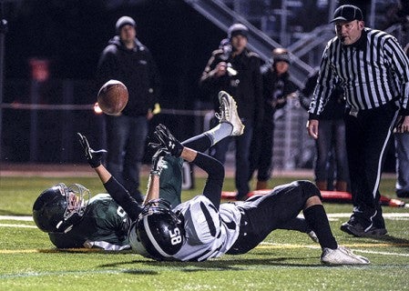 Blooming Prairie's Tristen Haberman reaches up for the ball on a circus-style catch to score at the end of the second quarter against Rushford-Peterson in the Section 1A championship Saturday night in Rochester. Eric Johnson/photodesk@austindailyherald.com