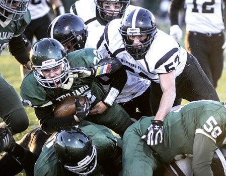 Blooming Prairie's Scott Romeo looks over to the sticks after helping making a stop on Faribault's Cole Kingsley during the first quarter of the Section 1A championship Saturday night in Rochester. Eric Johnson/photodesk@austindailyherald.com