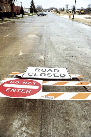 A “road closed” sign lays on its side as a car accesses the newly opened Main Street North Friday afternoon. Eric Johnson/photodesk@austindailyherald.com