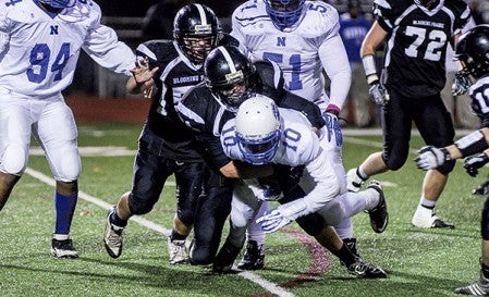 Blooming Prairie's Mitchell Jones tackles Minneapolis North's Tyler Johnson in the third quarter of the Class A Minnesota State Football Tournament quarterfinals in Richfield. Eric Johnson/photodesk@austindailyherald.com