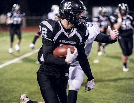 Blooming Prairie's Jake Decker carries on a run in the third quarter against Minneapolis North in the quarterfinals of the Class A Minnesota State Football Tournament Friday night in Richfield. Eric Johnson/photodesk@austindailyherald.com