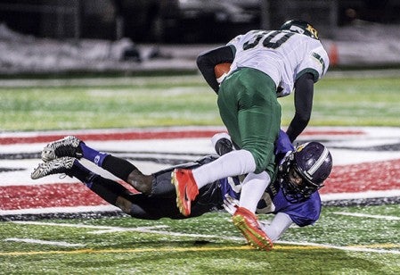 Grand Meadow's Cody Ojulu tackles Kittson County Central's Carson Thorsteinson during the third quarter in the Minnesota State Nine Man semifinals Friday night in St. Cloud. Eric Johnson/photodesk@austindailyherald.com