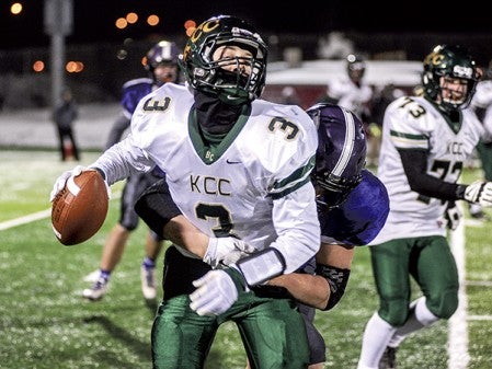 Grand Meadow's Blake Benson hits Kittson County Central quarterback Dylan Olsonawski in the third quarter Friday night in their semifinal matchup in the Minnesota State Nine Man State Tournament in St. Cloud. Eric Johnson/photodesk@austindailyherald.com