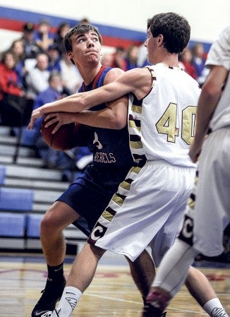 Southland's Josh Anderson looks to the hoop while pressured by Chatfield's Dan Narveson during the first half Friday night in Adams. Eric Johnson/photodesk@austindailyherald.com