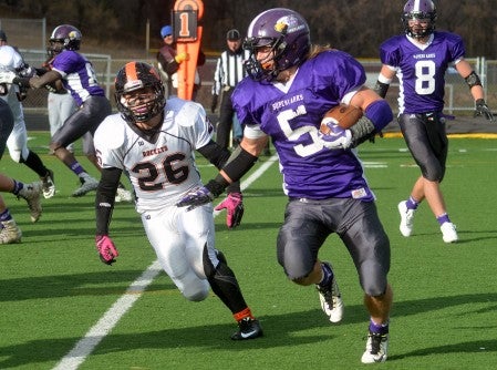 Grand Meadow's Landon Jacobson runs past Noah Thompson Saturday. -- Rocky Hule/sports@austindailyherald.com