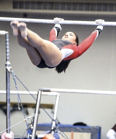 Austin's Jennifer Boyle performs on the uneven parallel bars during the Winter Warm-up Saturday at the YMCA. Eric Johnson/photodesk@austindailyherald.com