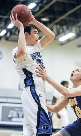 Riverland's Jeremy Stuart looks to dump inside during the first half against NIACC Wednesday night at Riverland Community College. Eric Johnson/photodesk@austindailyherald.com