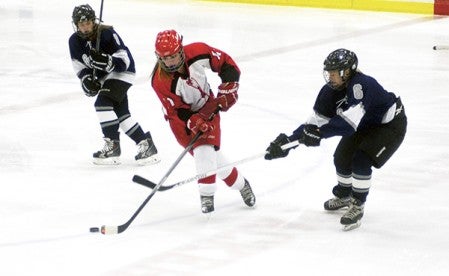 Austin's Brandi Myers handles the puck against Rochester Century in Riverside Arena Tuesday. -- Rocky Hulne/sports@austindailyherald.com