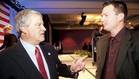  Austin Bruins head coach Chris Tok, right, listens to former Austin Mavericks head coach Lou Vairo after the U.S. Hockey Hall of Fame ceremony at the Minneapolis Marriott City Center on Dec. 4. 