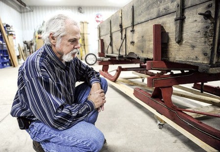 Jim Staley describes the detail of the bobsled he has restored as well as the pinstriping done by local artist Jeremy Pedersen. Eric Johnson/photodesk@austindailyherald.com
