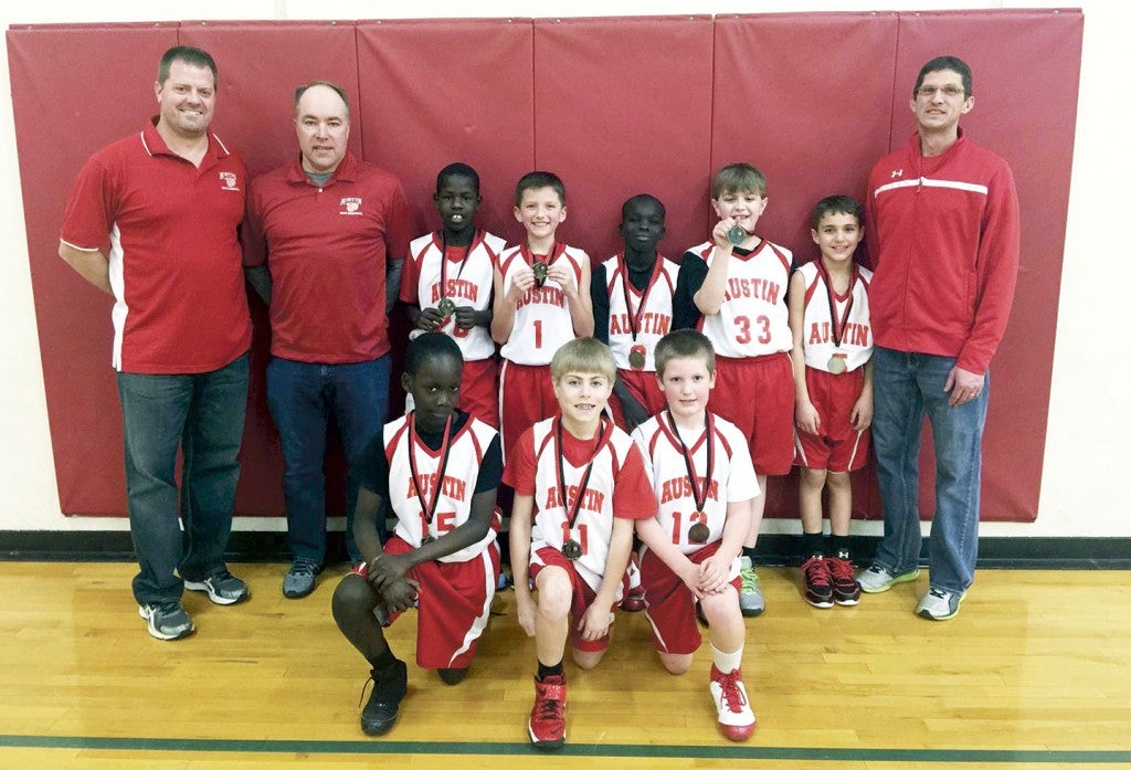 The Austin Youth Basketball fourth grade team finished first in the NRHEG Tournament Jan. 10.  Back row (left to right): Coach Brian Schneider, coach Dan Ransom, Cham Okey, Jacob Herrick, Ater Manyuon, Mason Pacholl, Isaac Osgood, and coach Jeremy Herrick; front row: Jenup Chop, Peyton Ransom and Christopher Schneider. Not Pictured:  Joe Ewing and Brenden Moriarity. -- Photo Provided