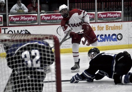 Adam Maxfield watches his slap shot hurl towards the net against Dodge County in Riverside Arena Tuesday. -- Rocky Hulne/sports@austindailyherald.com