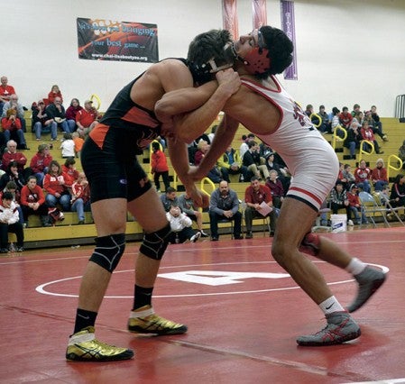 Austin's Brandon Cotter wrestles against Winona's Mason Henke in Packer Gym Tuesday. -- Rocky Hulne/sports@austindailyherald.com