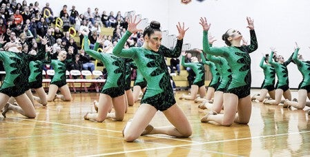 Olivia Hunt flashes a fierce look to the crowd during the Austin Packers Dance Team's high kick performance Saturday during the Section 1AA competition in Packer Gym. Eric Johnson/photodesk@austindailyherald.com