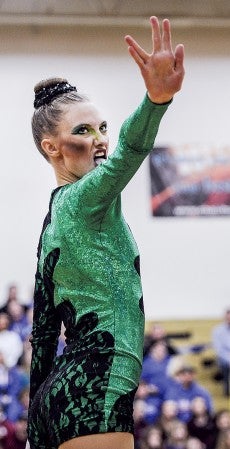 Nikki Summerfield performs with the Austin Packers Dance Team during the high kick competition of Section 1AA competition Saturday in Packer Gym. Eric Johnson/photodesk@austindailyherald.com