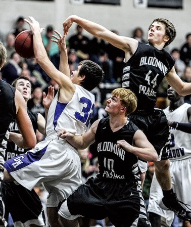 Blooming Prairie's Jake Decker (44) knocks the ball away from Grand Meadow's Trevor Sloan during the first half Friday night in Blooming Prairie. Eric Johnson/photodesk@austindailyherald.com