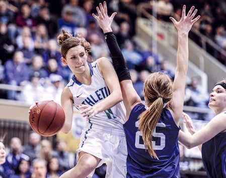 Lyle-Pacelli's Sarah Holtz passes around Goodhue's Sydney Lodermeier in the first half of the Section 1A West championship Saturday night at Mayo Civic Center in Rochester. Eric Johnson/photodesk@austindailyherald.com