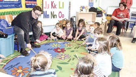 Aric Bieganek of the MacPhail Center for Music leads preschool students on a drumming exercise Wednesday at the Community Learning Center. 