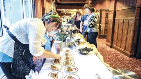 Chef Kristine Wolner readies her dessert, pecan pie with candied smoked pecans, as people lined up for tasting at the fourth annual Foodie Throwdown Saturday night at the Hormel Historic Home. Photos by Eric Johnson/photodesk@austindailyherald.com