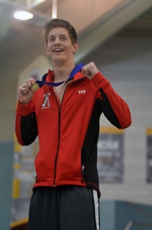 Austin's Craig Heimark displays his first place medal.