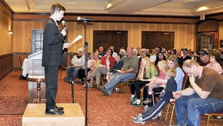 Ellis Middle School student Steven Conradt recites his poem in front of a packed crowd at the annual Night For Our Poets Tuesday at the Hormel Historic Home.  Trey Mewes/trey.mewes@austindailyherald.com