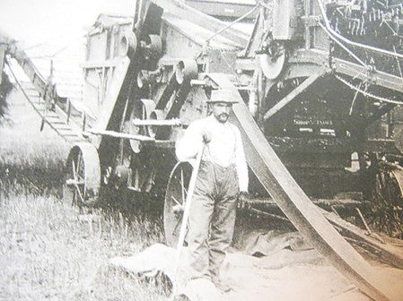 An early photo of Snyder working with a thresher.  Photo provided