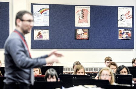 Old Band Blast posters line the walls of the Austin High School band room as it rehearses for this year's Band Blast Thursday. Eric Johnson/photodesk@austindailyherald.com