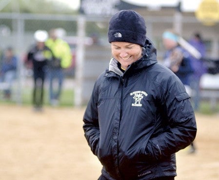 Blooming Prairie head softball coach Ali Mach takes a  moment to smile during her team’s win over  Glenville-Emmons in BP Monday. Mach has now won  200 career games. 