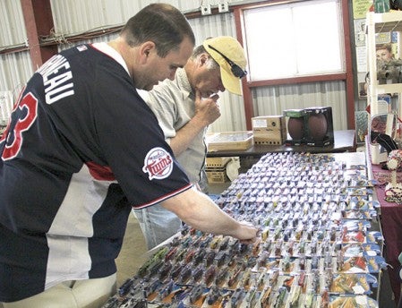 Don Daily of Austin, left, and Ken Dick of Rochester look over a table of Hot Wheels cars at the Three Rivers Antiques and Flea Market Saturday at the Mower County Fairgrounds. 