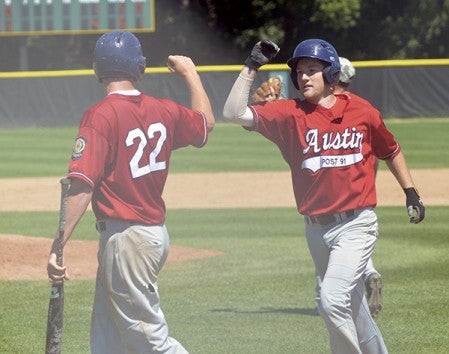 Austin's Nik Gasner, left, and Ethan Horstmann, right, celebrate a run scored as Austin Post 91 beat Rochester John Marshall at Mayo in Rochester Saturday. Rocky Hulne/sports@austindailyherald.com