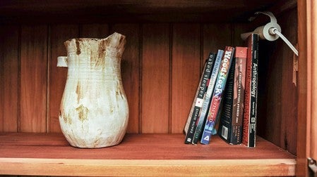 A pottery jug rests on a book self, a product of Jesse Smith who is an artist/musician and art teacher at I.J. Holton Intermediate School. Eric Johnson/Austin Living