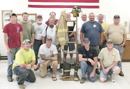 Firefighters with the Dexter Volunteer Fire Department stand next to the memorial ladder donated by Worlein Funeral Home. Photo provided