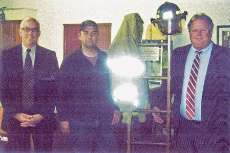 Worlein Funeral Directors Dan McRaith (far left) and Mark McGuire (far right) stand with Brownsdale Fire Chief David Pike next to the memorial ladder given to the Brownsdale Volunteer Fire Department by Worlein Funeral Home.  Photo provided