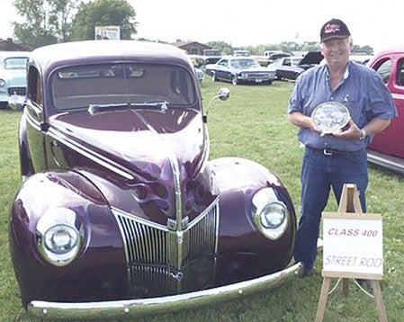 Craig Patterson from St. Ansgar holds an award for winning his class with he and his wife Ramona’s car. Photos provided