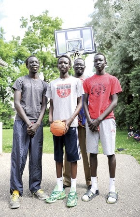 The Dengs have dived head-first into the basketball program in Austin. Brothers Ngor Deng, from left, Deng Deng and Dongoin Deng are just some of the increasing number of players joining the team of African descent. They are joined in the photo by their father Santino Deng.  Eric Johnson/photodesk@austindailyherald.com