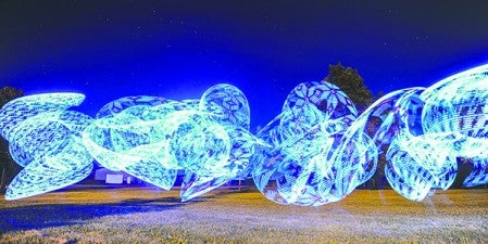 Rochelle Perleberg creats a pattern of light as she hula-hoops across the time-lapsed frame. Eric Johnson/photodesk@austindailyherald.com