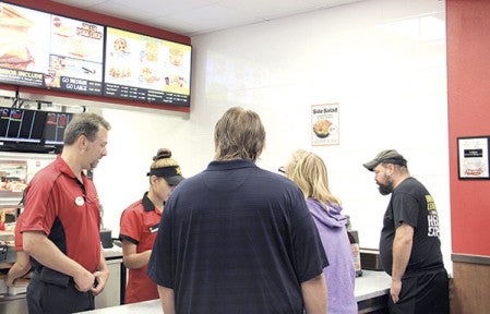 Customers order at the new Hardees at 1406 Fourth St. NW Tuesday morning around 7:30 a.m.  Jason Schoonover/jason.schoonover@austindailyherald.com