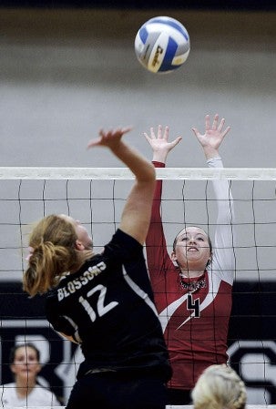 Austin’s Abi Collins puts up a block on Blooming Prairie’s Courtney Wobschall during game two of their match Tuesday night in Blooming Prairie. Eric Johnson/photodesk@austindailyherald.com