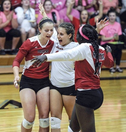 Austin libero Kelsey Sederquest, center, celebrates with teammates Shayley Vesel and Awenia Nywesh after a point in game one against Blooming Prairie in Blooming Prairie. Eric Johnson/photodesk@austindailyherald.com