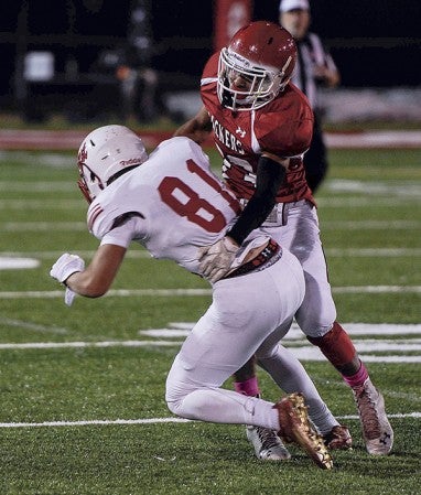 Austin’s Elijah Andersen wraps up Mankato West’s Brock Annexstad after a reception in the second quarter Friday night at Art Hass Stadium. Eric Johnson/photodesk@austindailyherald.com