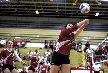 Austin’s Summer Maloney saves a ball during game two of a match against Mankato West Tuesday night in Packer Gym. Eric Johnson/photodesk@austindailyherald.com