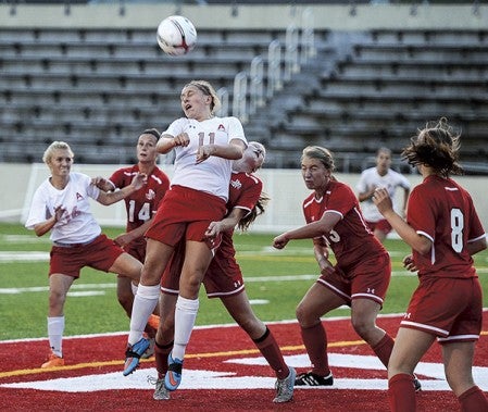 Austin’s Sydney Marsh goes for a header in front of Rochester John Marshall’s net during the first half Tuesday night at Art Hass Stadium. Eric Johnson/photodesk@austindailyherald.com