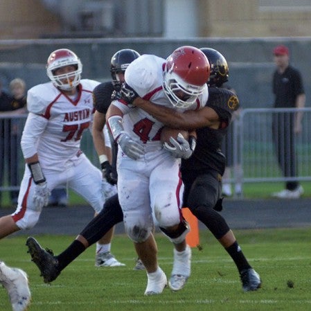 Austin's Jon Gallagher tries to shed a tackle on a kick return in Mankato East Friday. Rocky Hulne/sports@austindailyherald.com