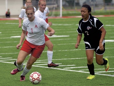 Austin's Chloe Summerfield handles the ball against Worthington's Savina Sonthana in Art Hass Stadium Saturday. Rocky Hulne/sports@austindailyherald.com