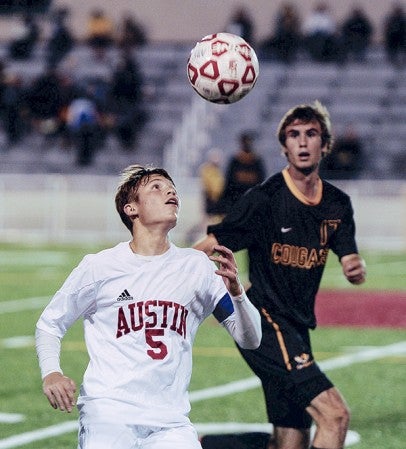 Austin’s Sean Baker keeps his eye on the ball during the first half against Mankato East Thursday night at Art Hass Stadium. Eric Johnson/photodesk@austindailyherald.com