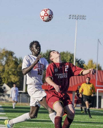 Austin’s Ochan Ochogi pressures Stewartville’s Paul Betcher in the first half of the team’s Section 1A match-up Tuesday at Art Hass.