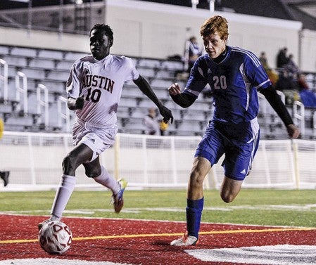 Austin’s Ochan Ochogi races Kasson-Mantorville’s Ross Wagener during the first half of their Section 1A quarterfinal game Friday night at Art Hass Stadium. Eric Johnson/photodesk@austindailyherald.com